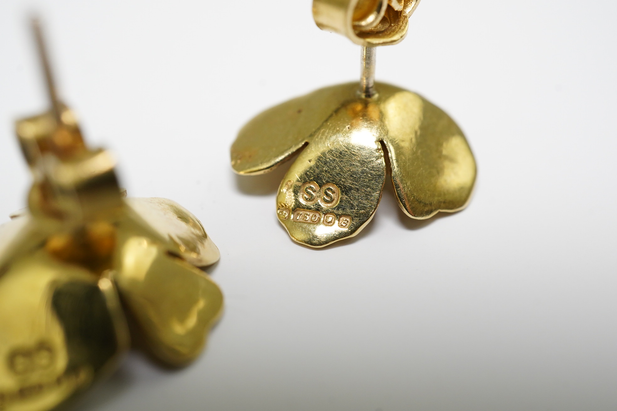 A pair of 1970's 18ct gold and single stone emerald set flower head earrings